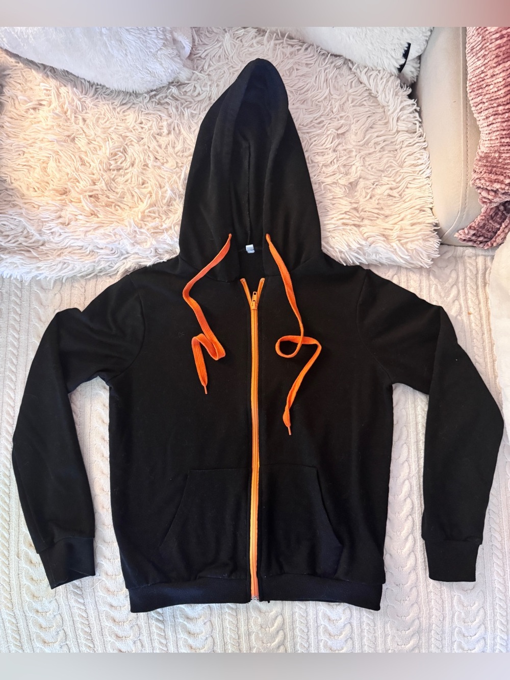 Black hoodie, orange zip, and hood strings. 
Ladies small